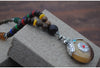 Collier "Symbole Bouddhiste Tibétain" en Bois Naturel - 9 modèles disponibles