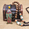 Collier "Symbole Bouddhiste Tibétain" en Bois Naturel - 9 modèles disponibles