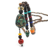 Collier "Symbole Bouddhiste Tibétain" en Bois Naturel - 9 modèles disponibles